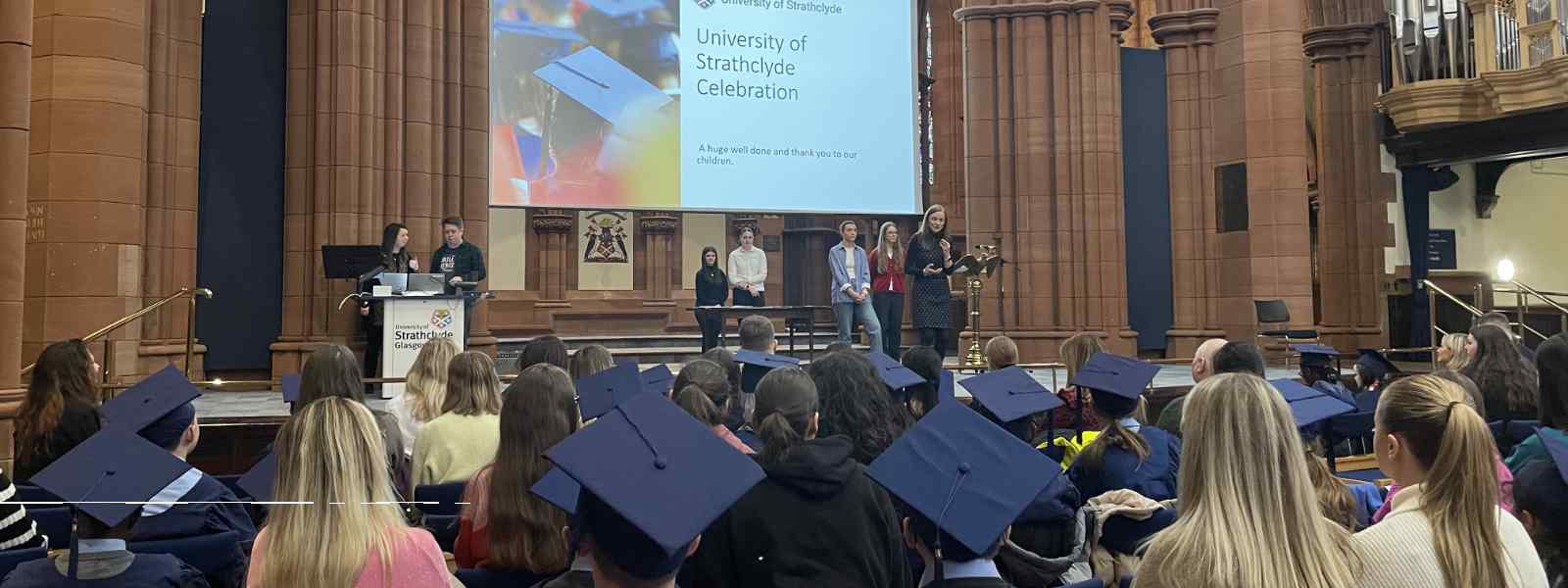 Literacy and Numeracy Clinic leader Jenny Carey addresses school pupils during their graduation ceremony at the Barony Hall   