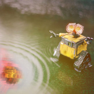 A robot looking at the reflection of a meteor in a puddle