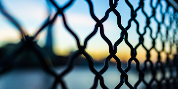 Wire fence with blurred view behind