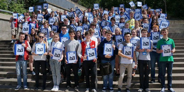 2014's Space School cohort standing on the stairs in rottenrow gardens with their space school booklets