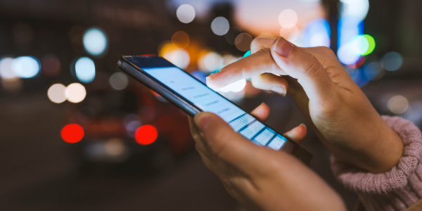 Close-up of a woman's hand scrolling on a social media screen on a mobile phone Close-up of a woman's hand scrolling on a social media screen on a mobile phone