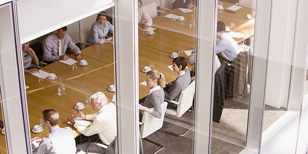View of business people sitting in conference room.
