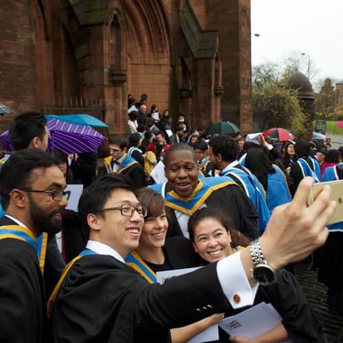 a group of students pose for a selfie straight after graduation