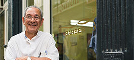 Man standing in front of a barber shop