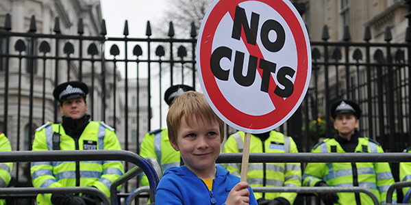 Young boy protesting about austerity cuts