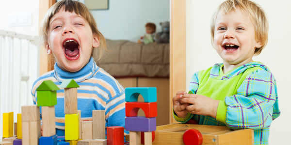 Two children playing with blocks