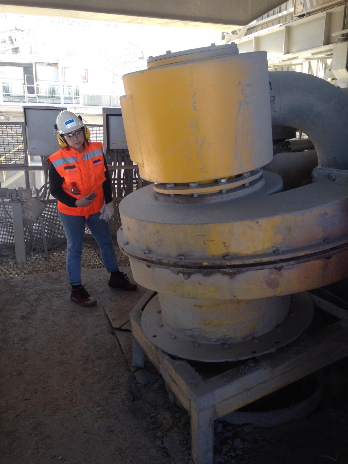 PhD student Ashlee Espinoza viewing a hydro-cyclone at Weir Group's facility in Santiago, Chile
