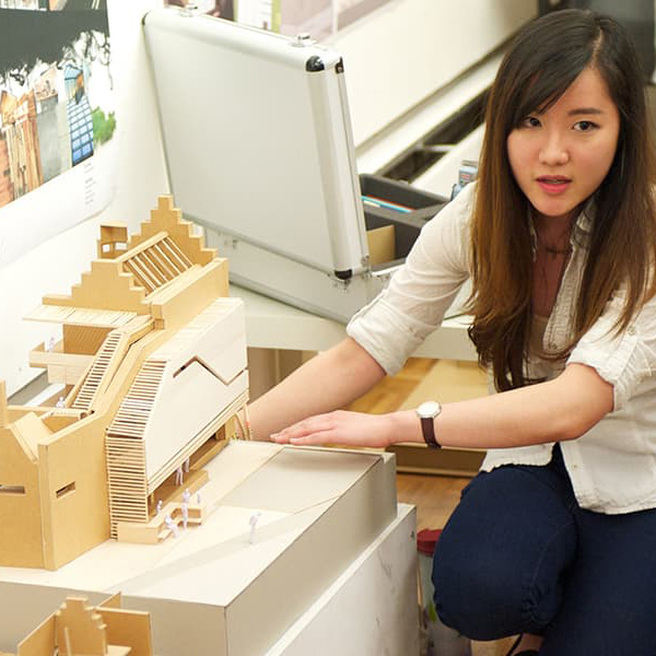 Female student with architecture model Female student with architecture model