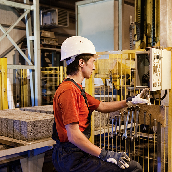 Male in hard hat checking machinery Male in hard hat checking machinery