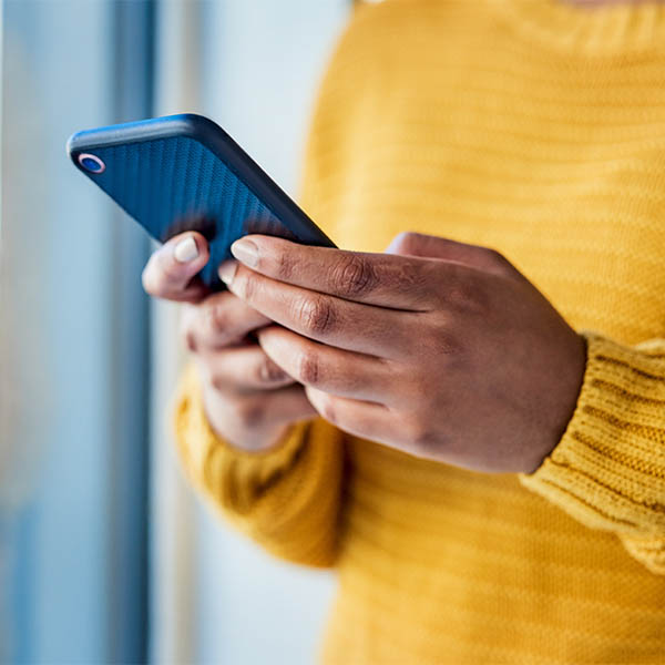Close up of someone's hands as they use a mobile phone. Close up of someone's hands as they use a mobile phone.