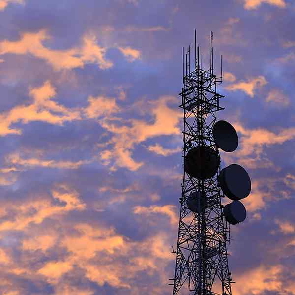 Telecommunication tower Antenna and satellite dish at sunset sky background Telecommunication tower Antenna and satellite dish at sunset sky background