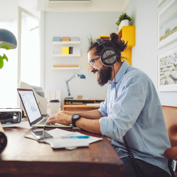 a man uses a laptop at a desk a man uses a laptop at a desk