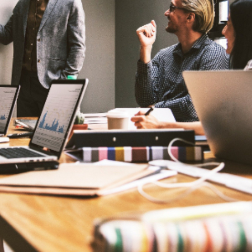 people gathered around table with laptops people gathered around table with laptops