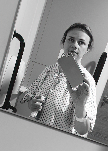 Mirror reflection of a woman in a hospital gown