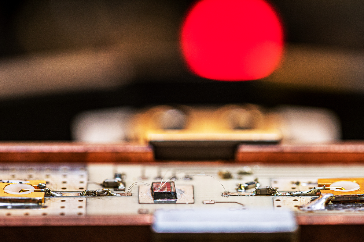 Close up of a circuit board with a red LED light in the background mimicking a sunset