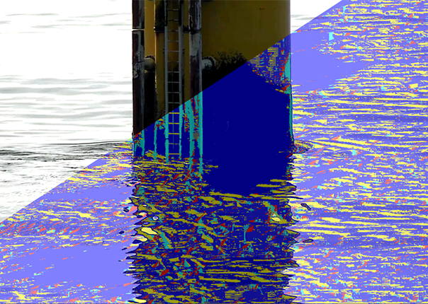 A video still of an offshore wind turbine base overlaid with a graphic that shows the impact of waves on the structure