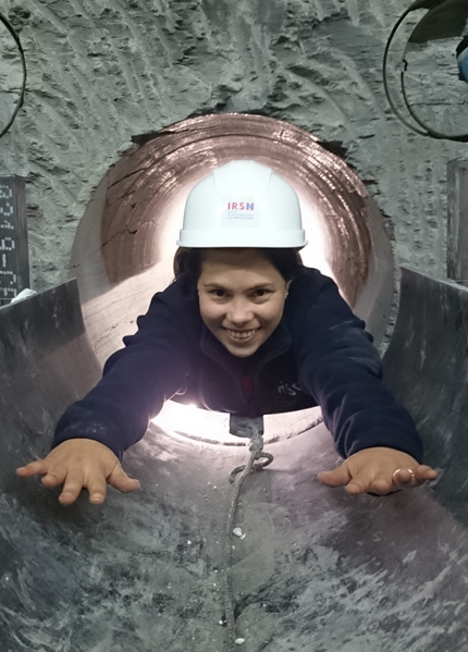 A researcher in a helmet in a tunnel