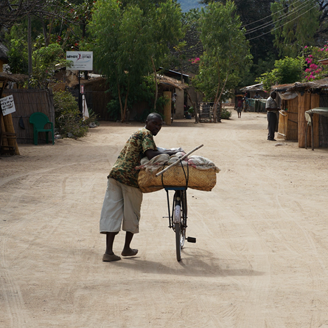 A Malawian farmer taking goods to market on his bicycle
