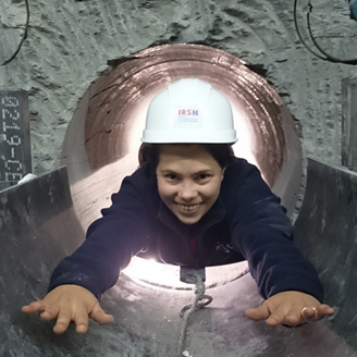 A researcher in a helmet in a tunnel 