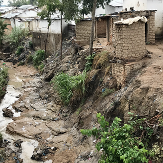 A riverine running past a shanty town in Africa