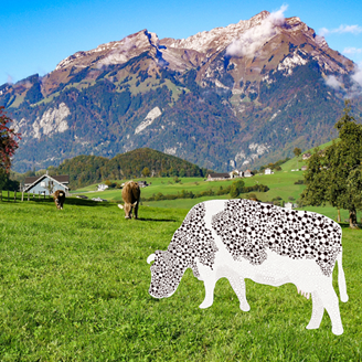 Cows in a field with mountains behind them. Cow at the front has been graphically illustrated with molecule patterns