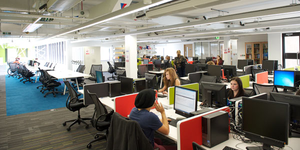 students sitting on computers studying