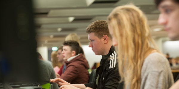 students use computers in a row