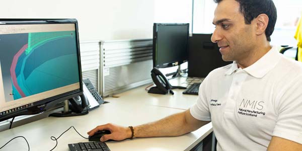 A member of AFRC staff sitting at a computer using process modelling software 