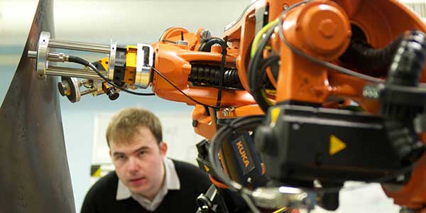 Researcher looking at a large drill.