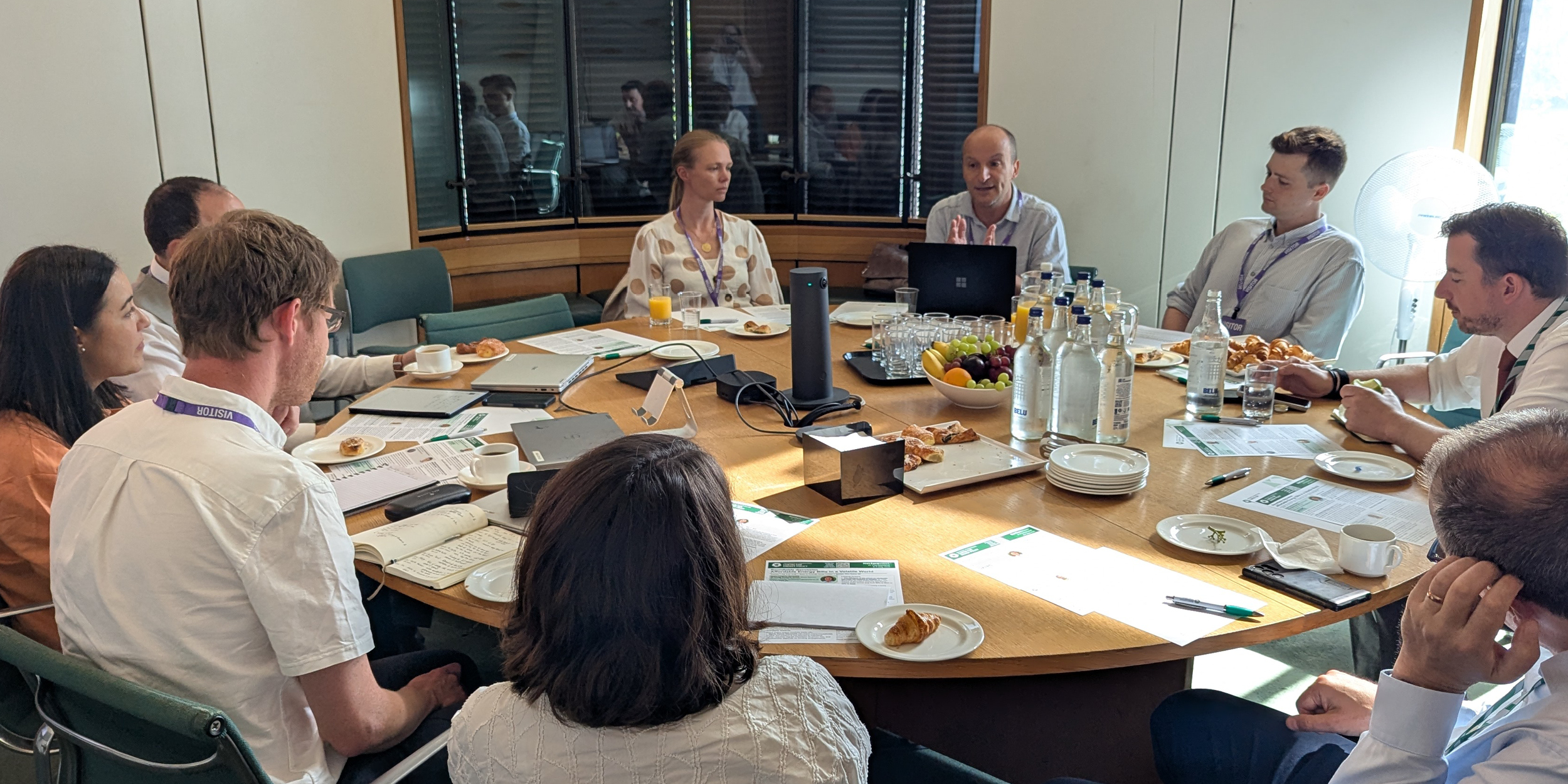 Researchers and MPs sitting around a table discussing energy affordability