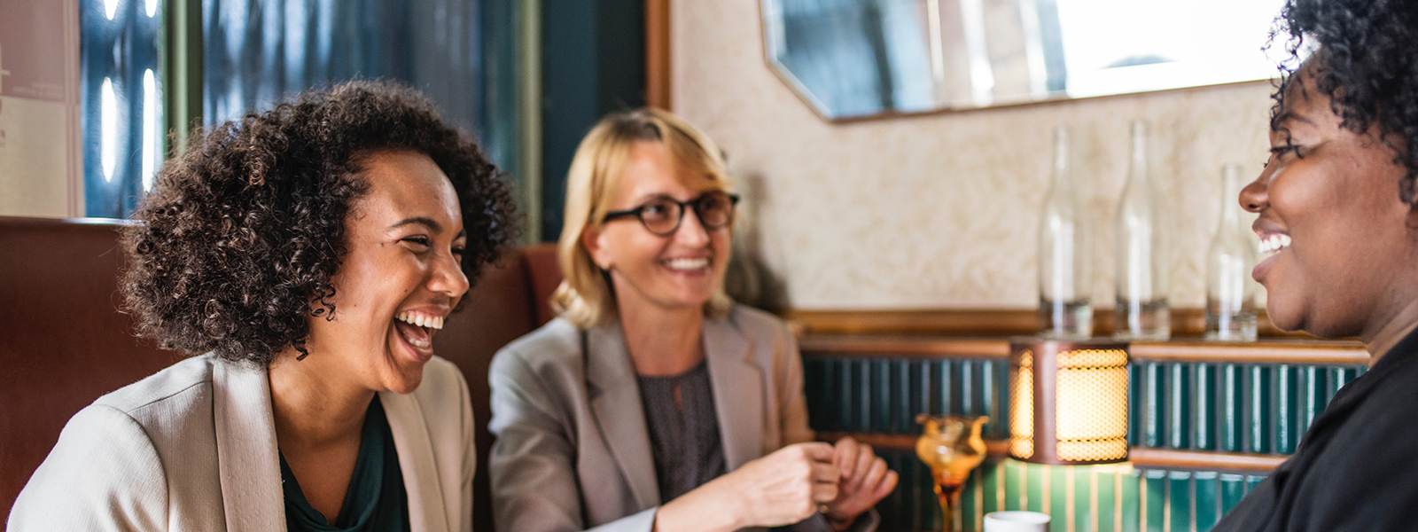 Three businesswomen talking in a cafe