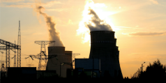 Pylons and a cooling tower at sunset