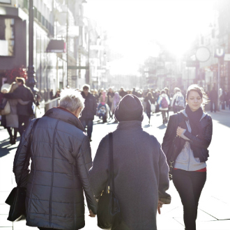 A woman walks down a busy street