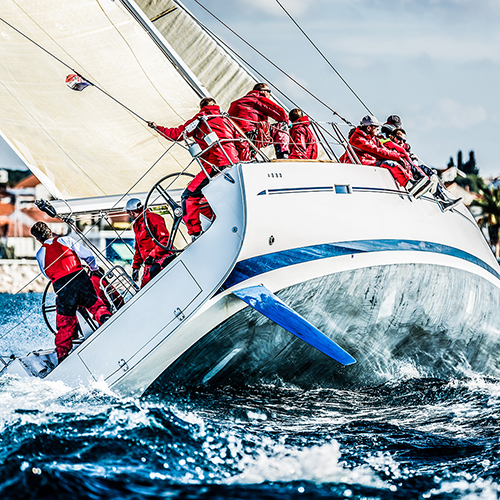 Sailing crew on sailboat during regatta.