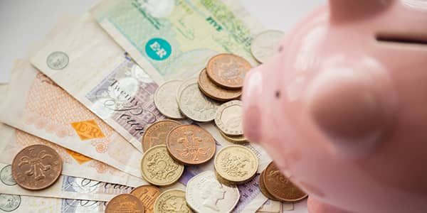 Piggy bank with banknotes and coins