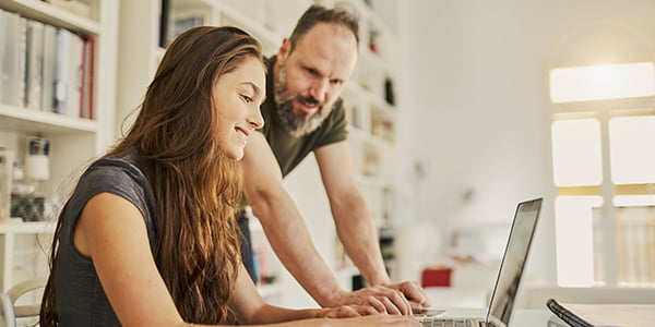 Parent and child working at a laptop