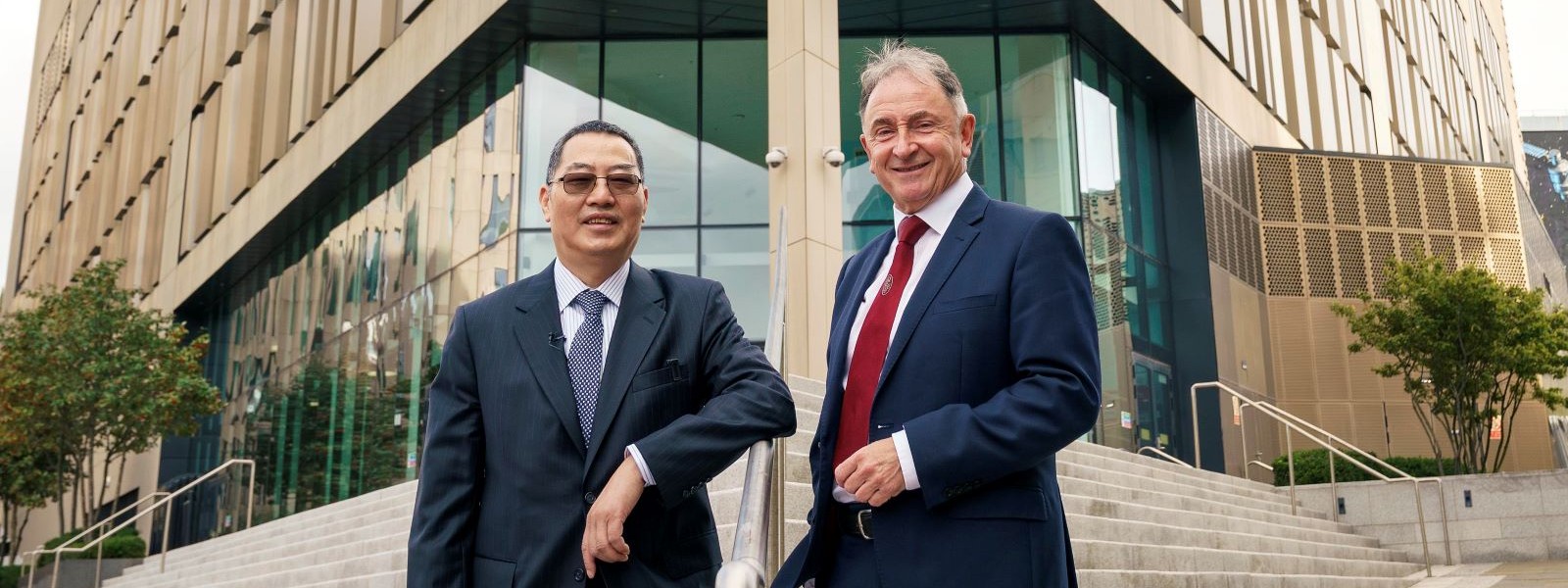 Dr Charles Huang and Professor Sir Jim McDonald on the steps of the Technology & innovation Centre