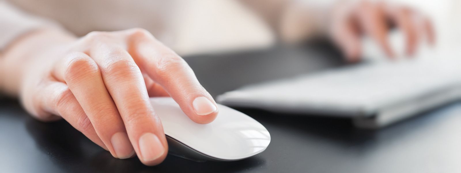 Woman's hand on computer mouse