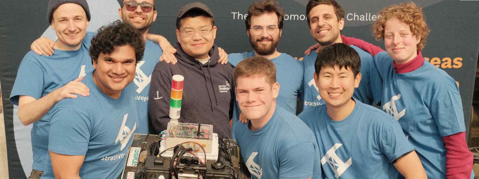 The StrathVoyager team with their Autonomous Surface Vehicle. Left to right: Marvin Wright; Nilesh Ohol; Charalampos Tsoumpris; Wang Zhao; Alexander Dixon; Panagiotis Louvros; Mauro Arcidiacono; Paul Lee; Kaja Gorska. Photo Paul Lee 