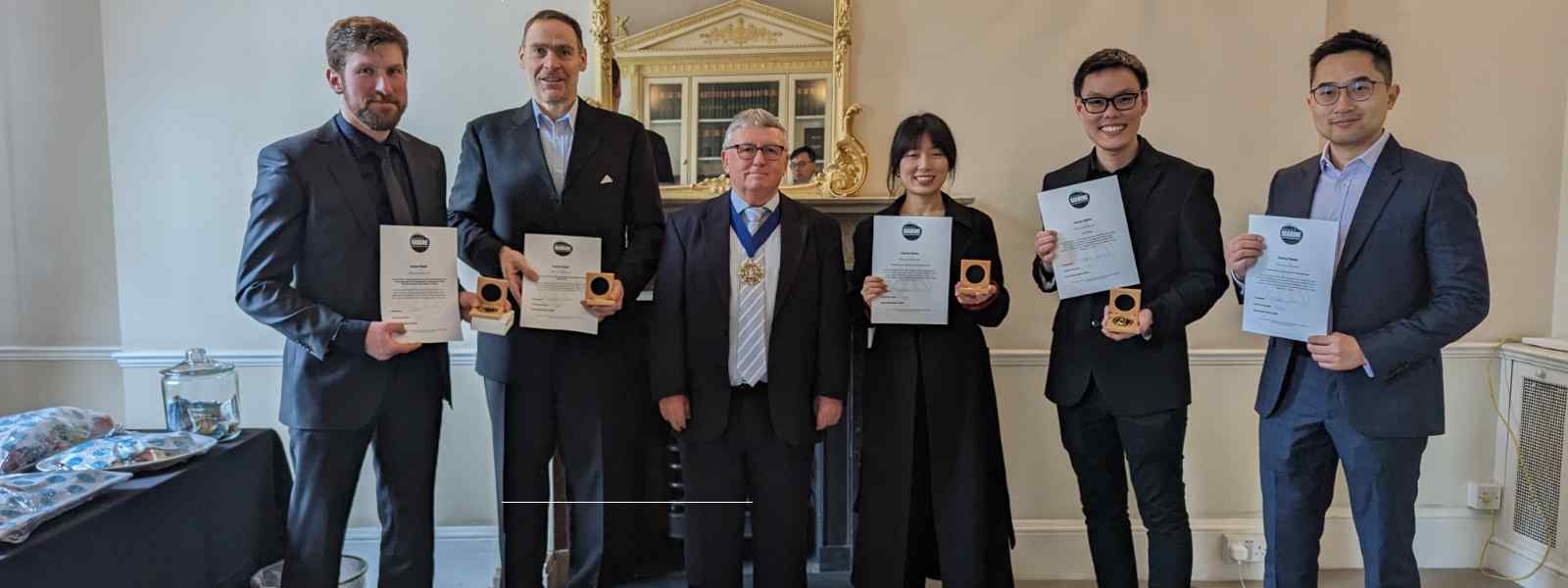 Strathclyde's Professor Gerasimos Theotokatos (second left) with other IMarEST award winnners receiving their medals and certificates from  IMarEST President Martin Shaw (third left). Photo courtesy of IMarEST