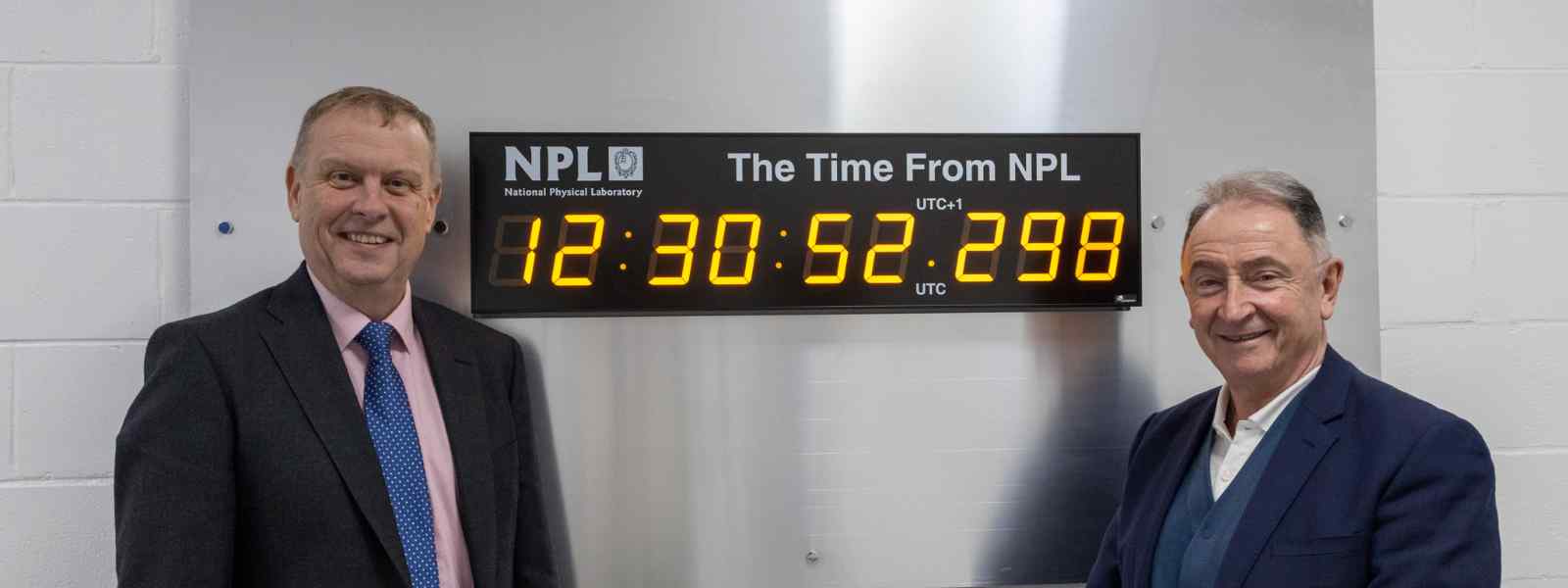 Strathclyde Principal and Vice-Chancellor Professor Sir Jim McDonald (right) with NPL CEO Dr Peter Thompson at the the NPL-enabled clock at the new innovation node at Strathclyde. Photo by NPL