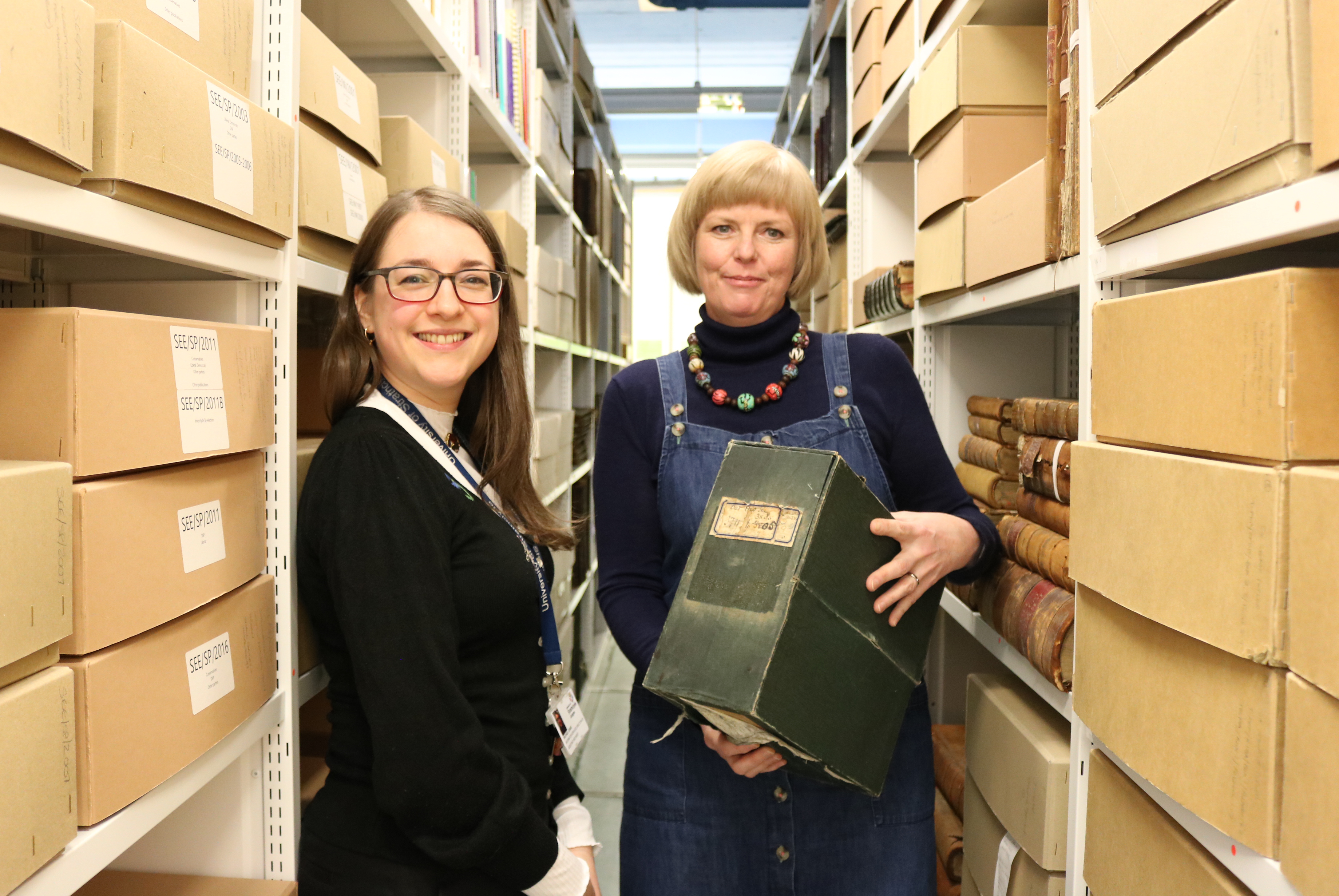 Strathclyde Archivist Rachael Jones (left) and Dr Eleanor Bell with the box in which the manuscript of The Dear Green Place was stored 