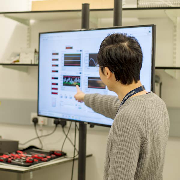 Professor Weijia Yuan pointing at monitor. Professor Weijia Yuan pointing at monitor.