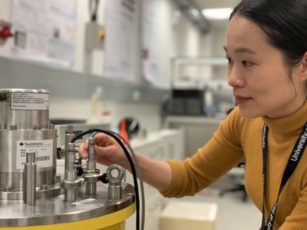 Dr Min Zhang adjusts equipment in the lab Dr Min Zhang adjusts equipment in the lab