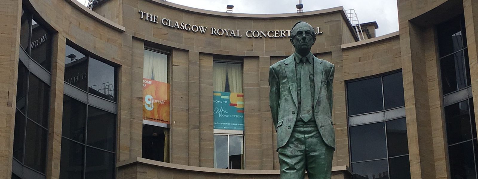 A statue of Scottish politician Donald Dewar standing in front of the entrance to Glasgow Royal Concert Hall