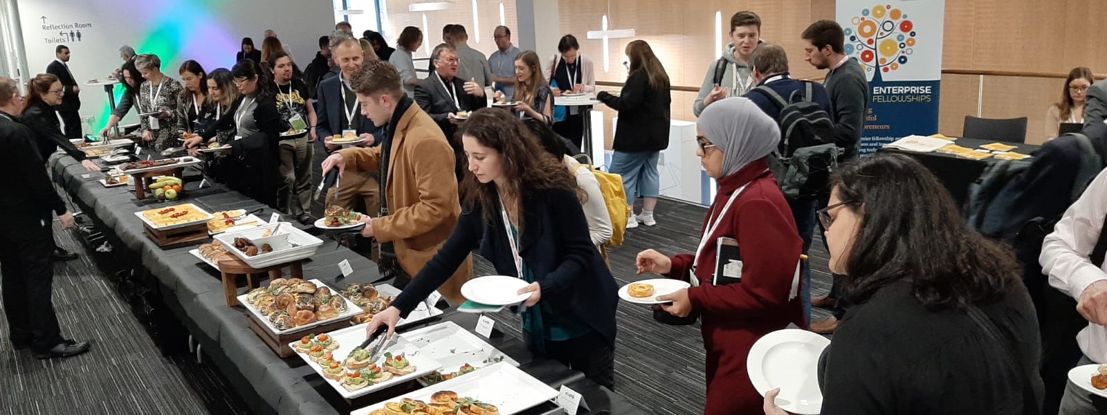 Delegates enjoying a buffet lunch at a conference in the Technology and Innovation Centre