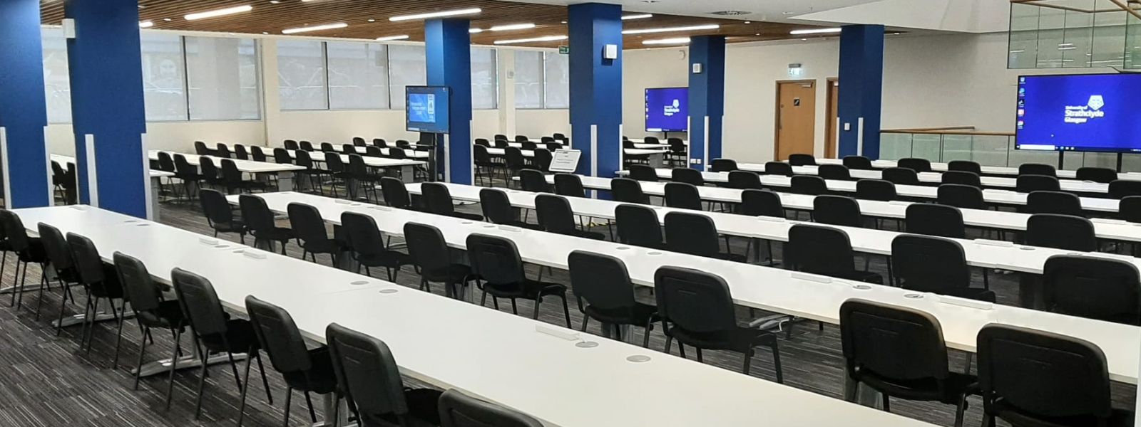 Tables and chairs set classroom style in the foyer for UCI media centre