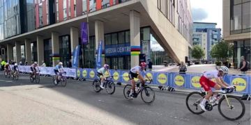 Women's Elite Road Race competitors cycle past the Technology and Innovation Centre