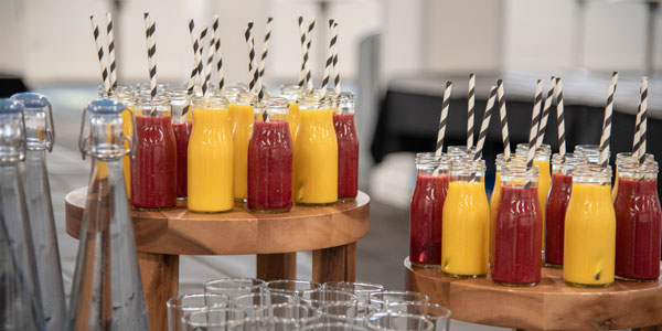 Bottles of orange and raspberry juice smoothies with straws.  Photo: Lucy Knott