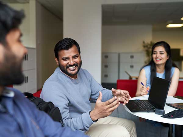 MBA students talking in common room.